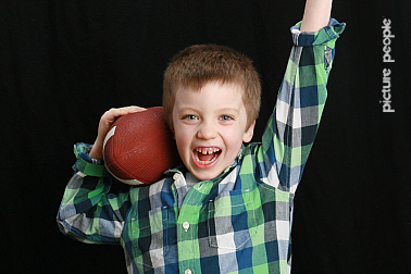 TJ posing with a football